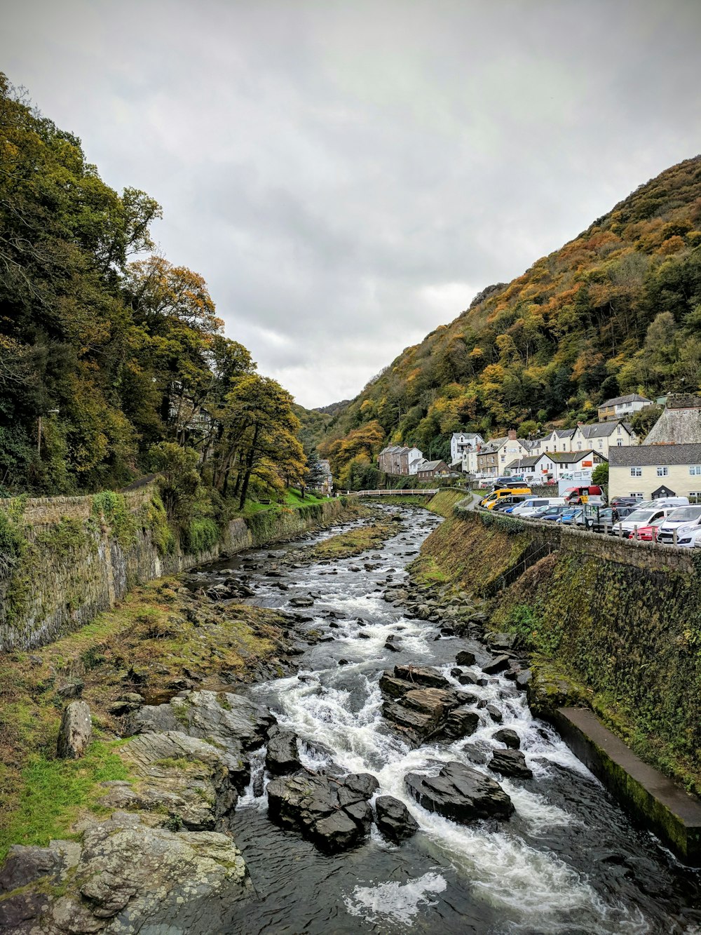 cars parked in edge of gorge at bank of river