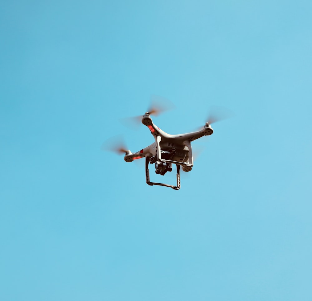 Drone quadricoptère blanc en vol