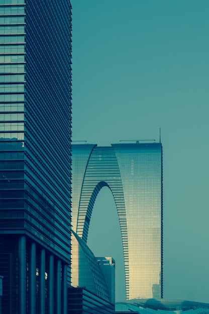 high rise glass building under clear blue sky