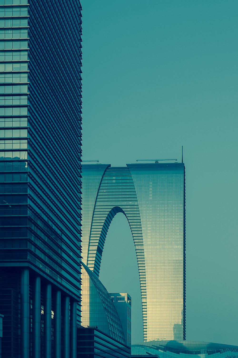 high rise glass building under clear blue sky