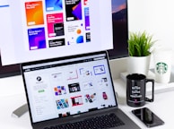 black and gray laptop computer beside black mug