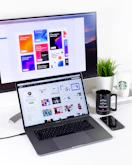 black and gray laptop computer beside black mug