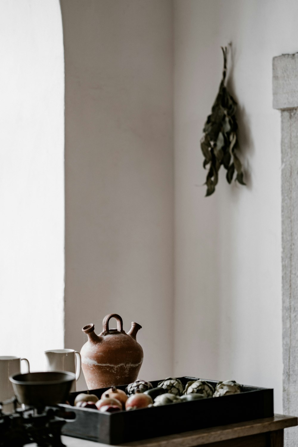 a table with a tea pot and cups on it