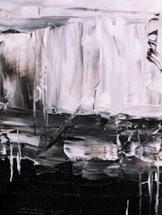 Large-scale canvas featuring bold brushstrokes in charcoal and off-white.