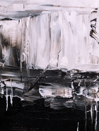 Abstract brushstrokes of black, white, and grey paint on a textured canvas