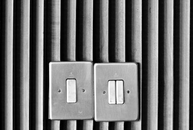 Close-up of modern electrical switches and sockets with a sleek design.