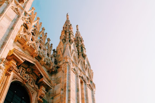 low-angle view of building during daytime in Duomo di Milano Italy