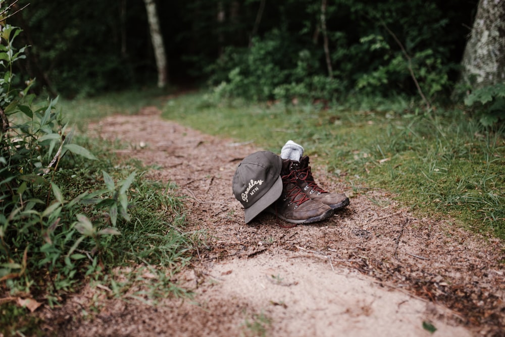 pair of brown boots and black fitted cap