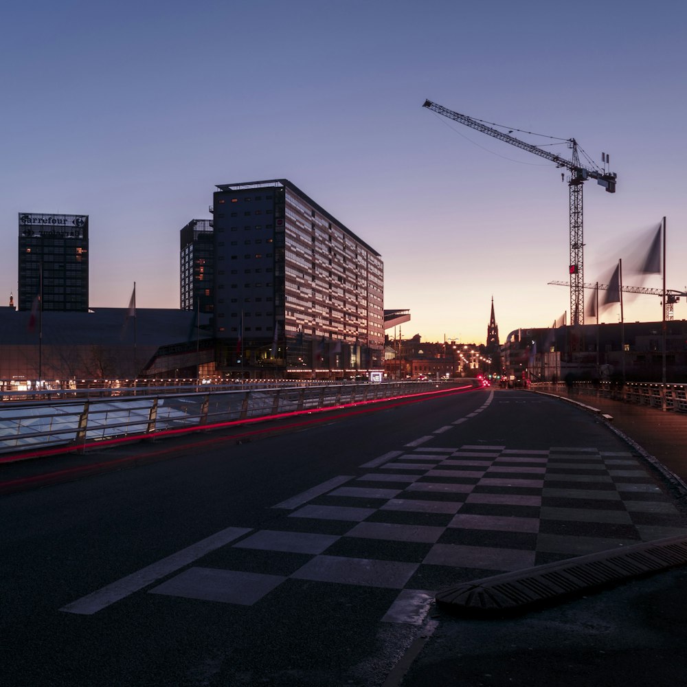 concrete building and crane during daytime