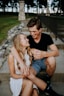 man holding the hand of a woman while siting on concrete staircase