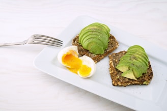 rectangular white platter of sliced food and eggs