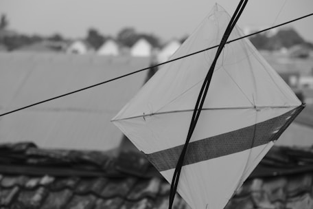 Close-up of vibrant kite strings tangled playfully in the wind