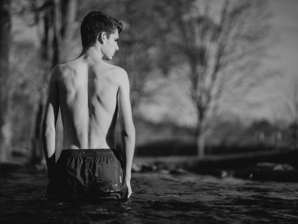 grayscale of man in body of water