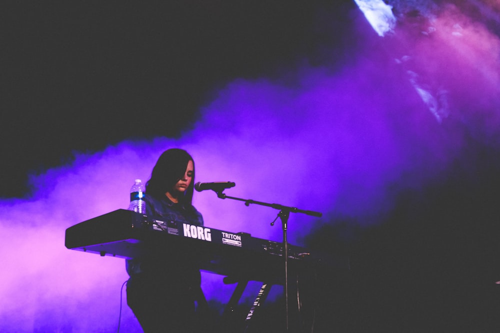 woman playing Korg electric keyboard