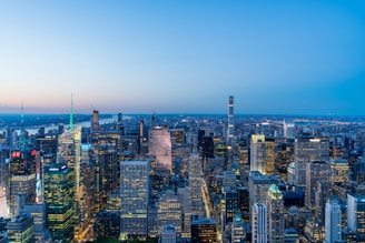 A panoramic view of a bustling commercial district with office buildings and retail spaces under a clear sky.