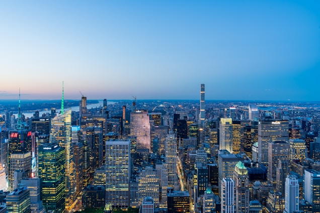 A panoramic view of a bustling commercial district with office buildings and retail spaces under a clear sky.