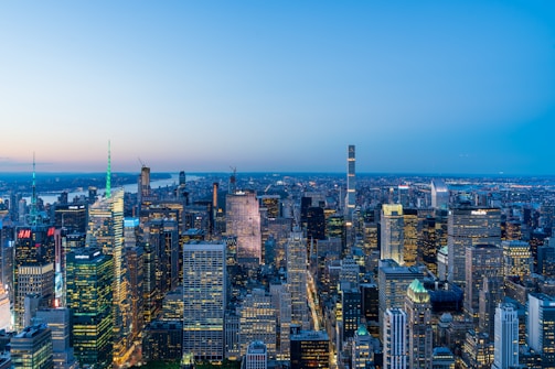 A panoramic view of a bustling Asian financial district at dusk, with skyscrapers glowing under a vibrant sky.