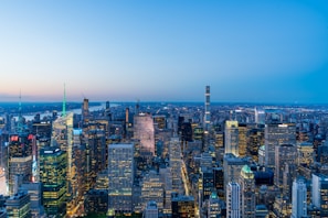 A panoramic view of a bustling Indian city skyline featuring iconic skyscrapers and illuminated streets.