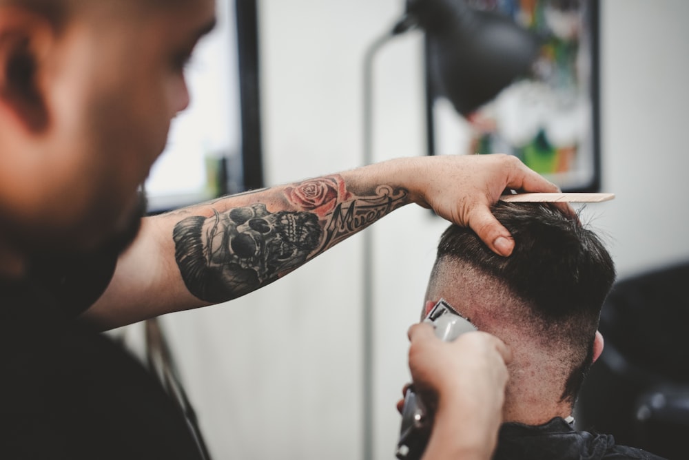 man cutting hair of man