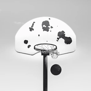 Host recording an episode of the podcast with a basketball hoop in the background