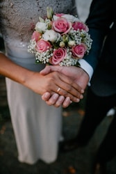 man and woman standing while holding hands