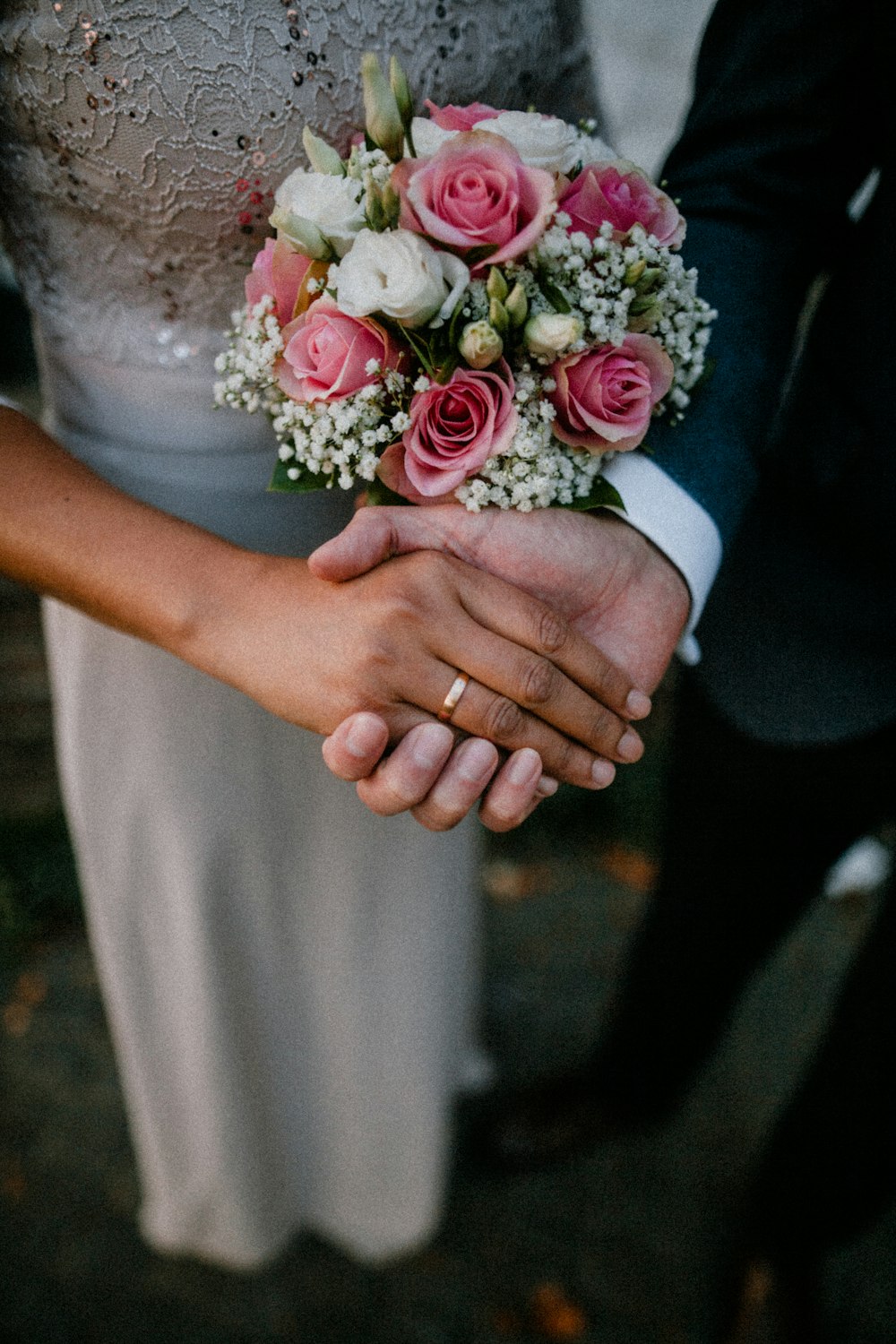 man and woman standing while holding hands