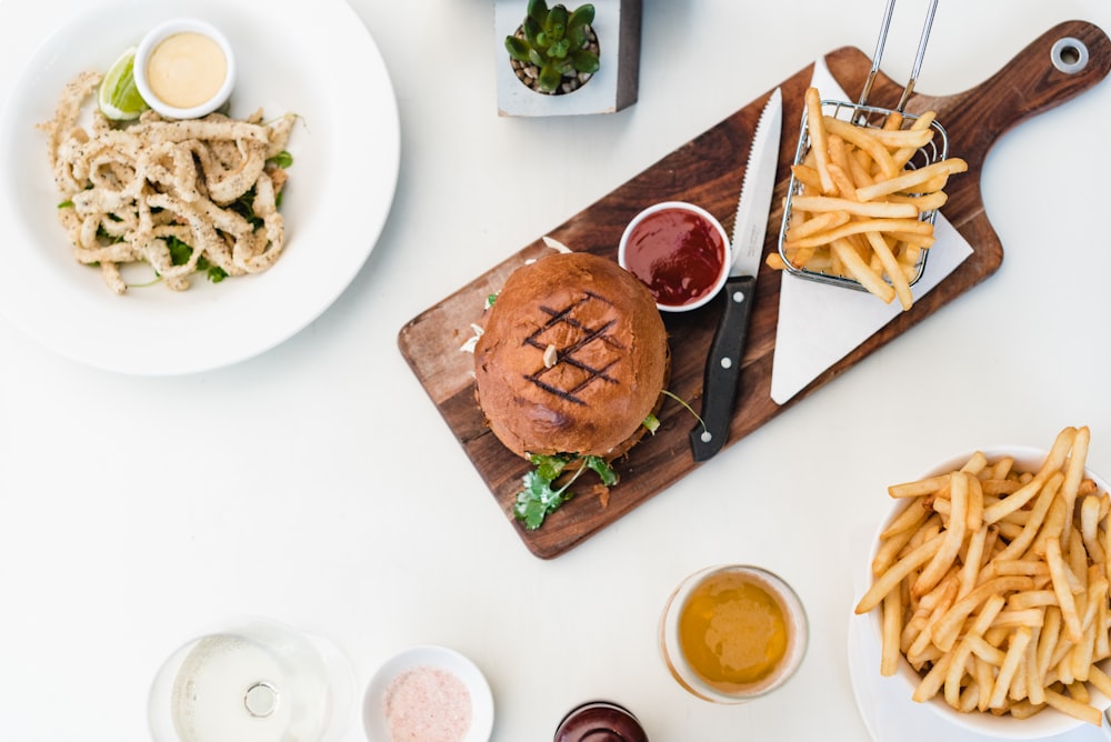 fries and meat on chopping board