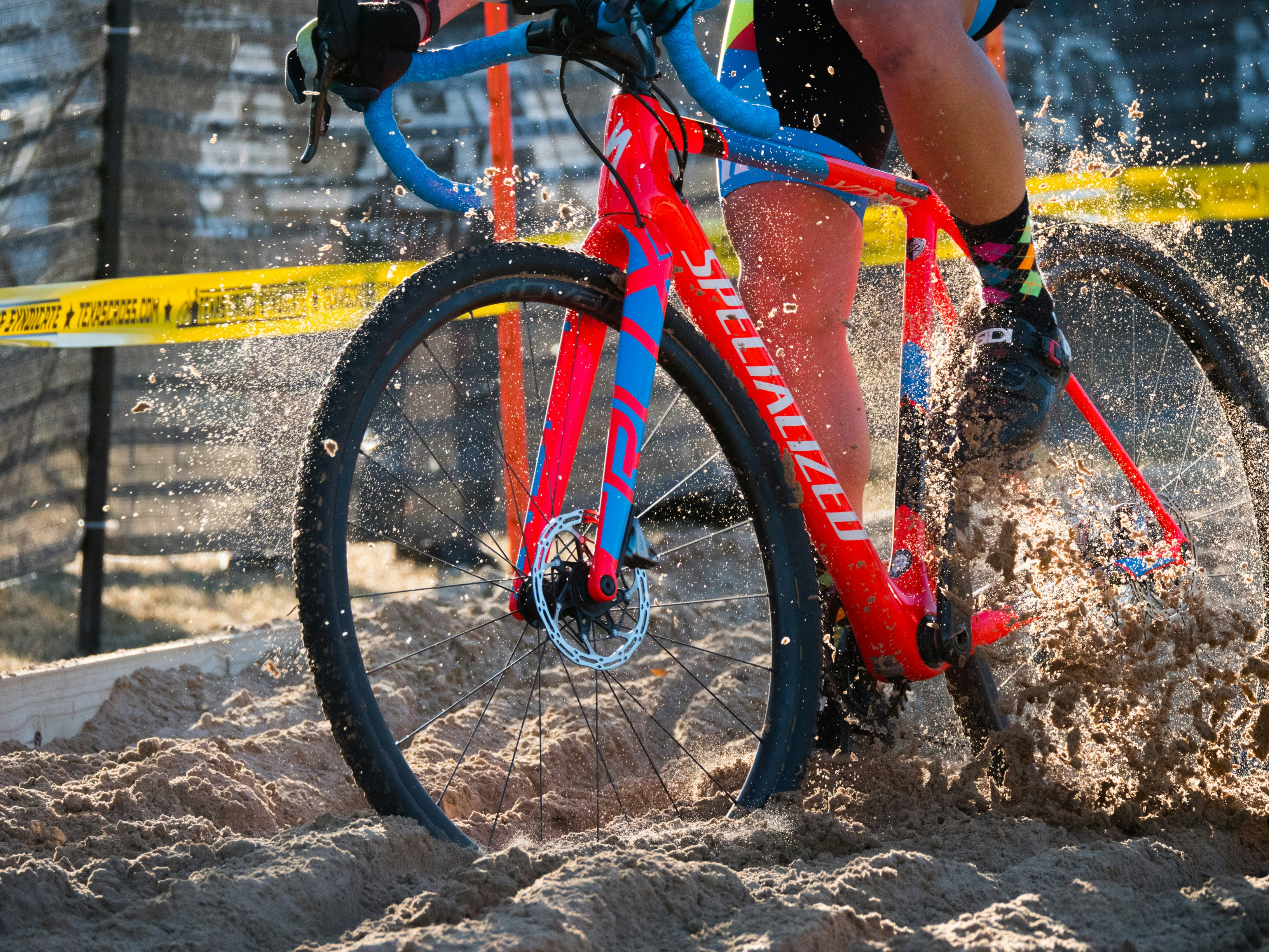 person riding red Specialized road bike