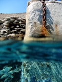 Underwater view of grout being applied to reinforce a submerged structure.