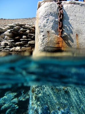 Underwater view of grout being applied to reinforce a submerged structure.
