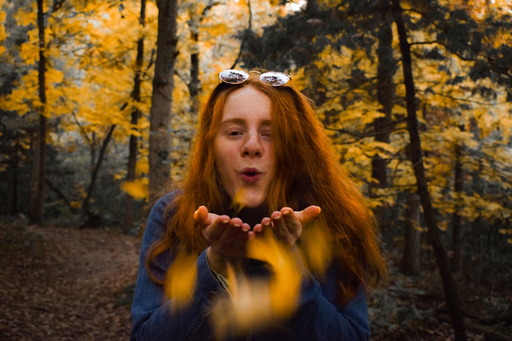 woman blowing near tree