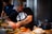man standing beside table while holding food