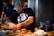 man standing beside table while holding food
