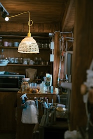 A cozy kitchen scene featuring wooden utensils hanging above a clean counter.