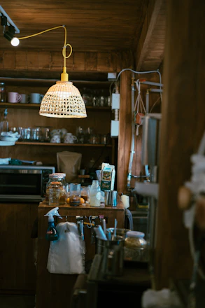 A cozy kitchen scene featuring neatly arranged cleaning tools and home essentials.