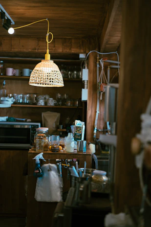 A cozy kitchen scene featuring neatly arranged wellness products and household essentials on a wooden countertop bathed in natural light.