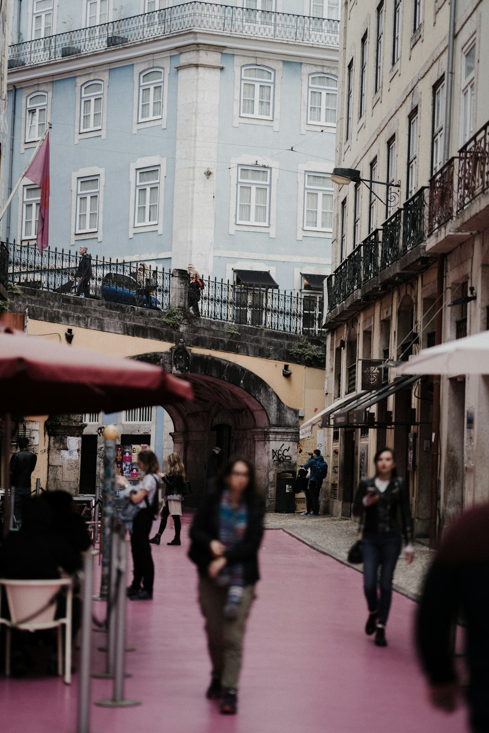 people walking beside buildings