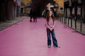 selective focus photography of girl on purple street