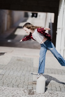 girl balancing on top of concrete stand