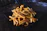 A close-up of a golden, crispy plate of fries with a cold chocolate shake beside it on a wooden table.