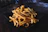 A close-up of a golden, crispy plate of fries with a cold chocolate shake beside it on a wooden table.