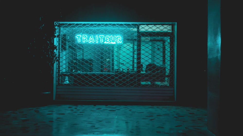 a green neon sign that reads trattecio in front of a building