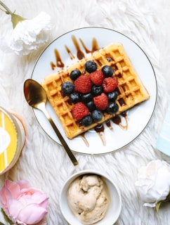 sandwich with strawberry and blackberry fruits on plate