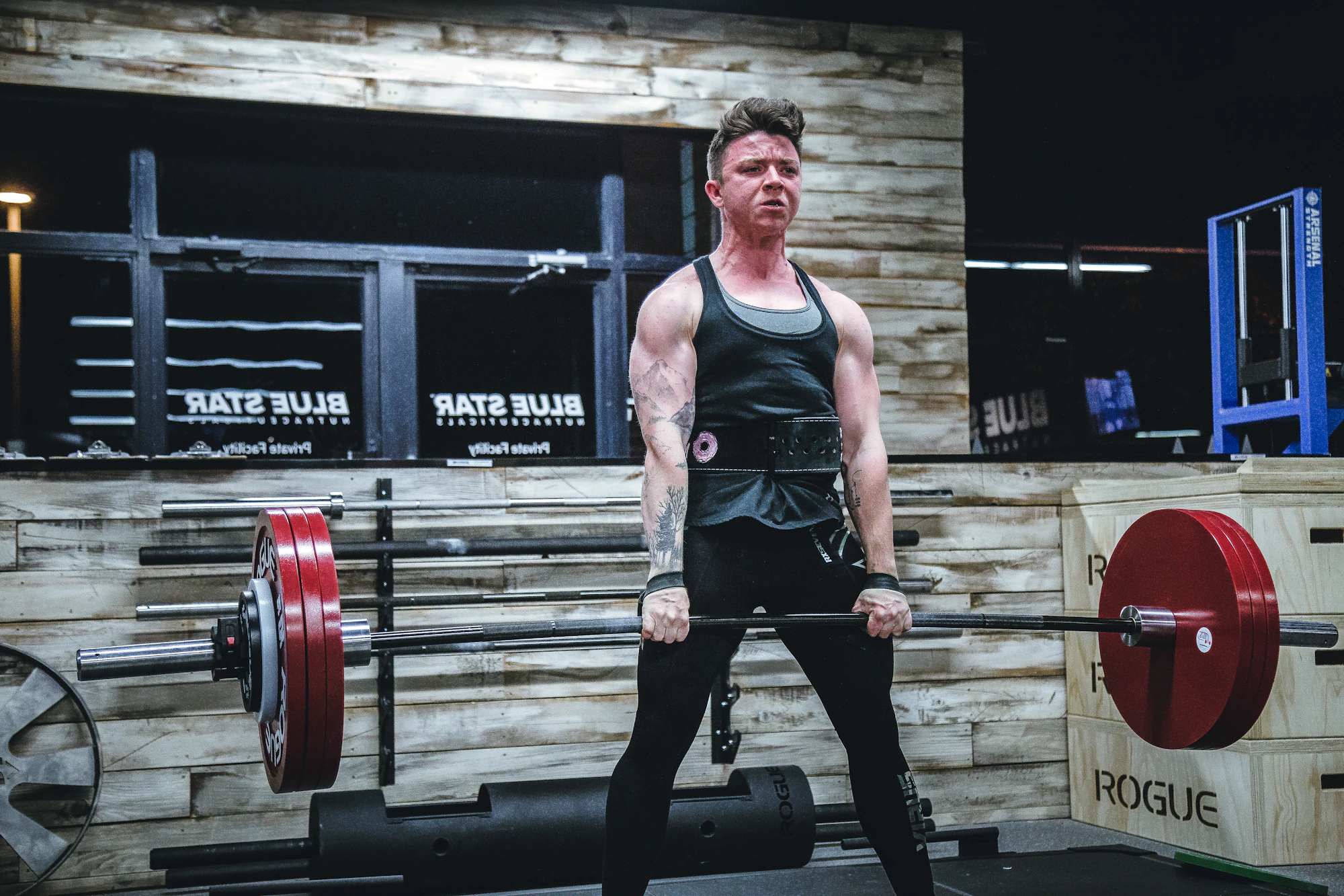 Powerlifter holding a loaded barbell in a strength gym