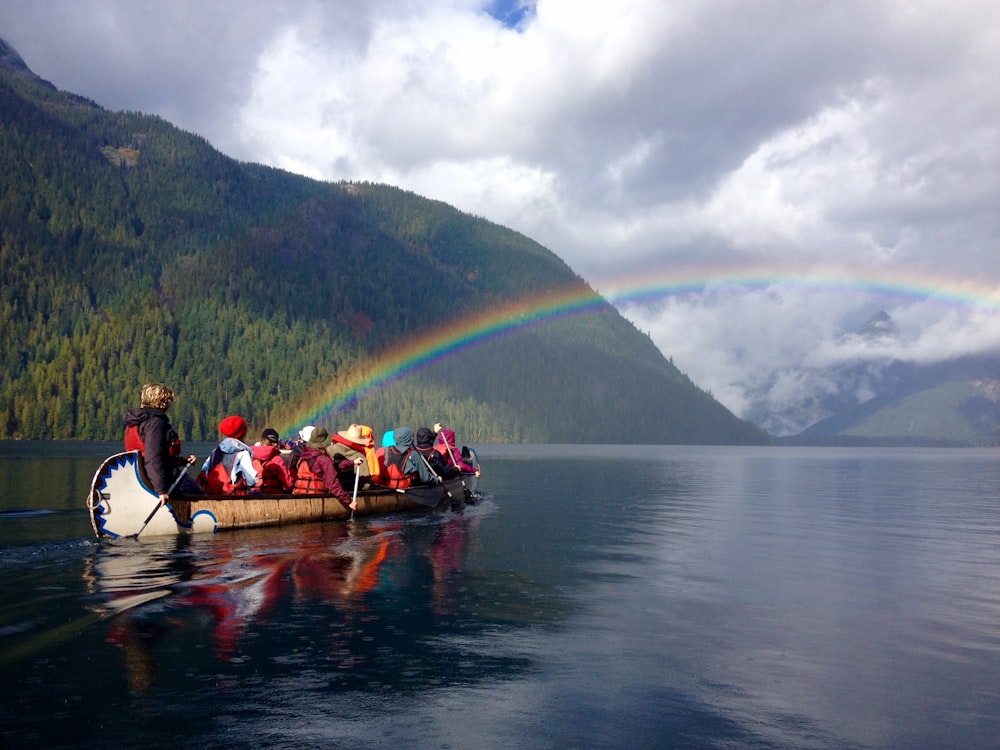 photography of people riding brown boat during daytime