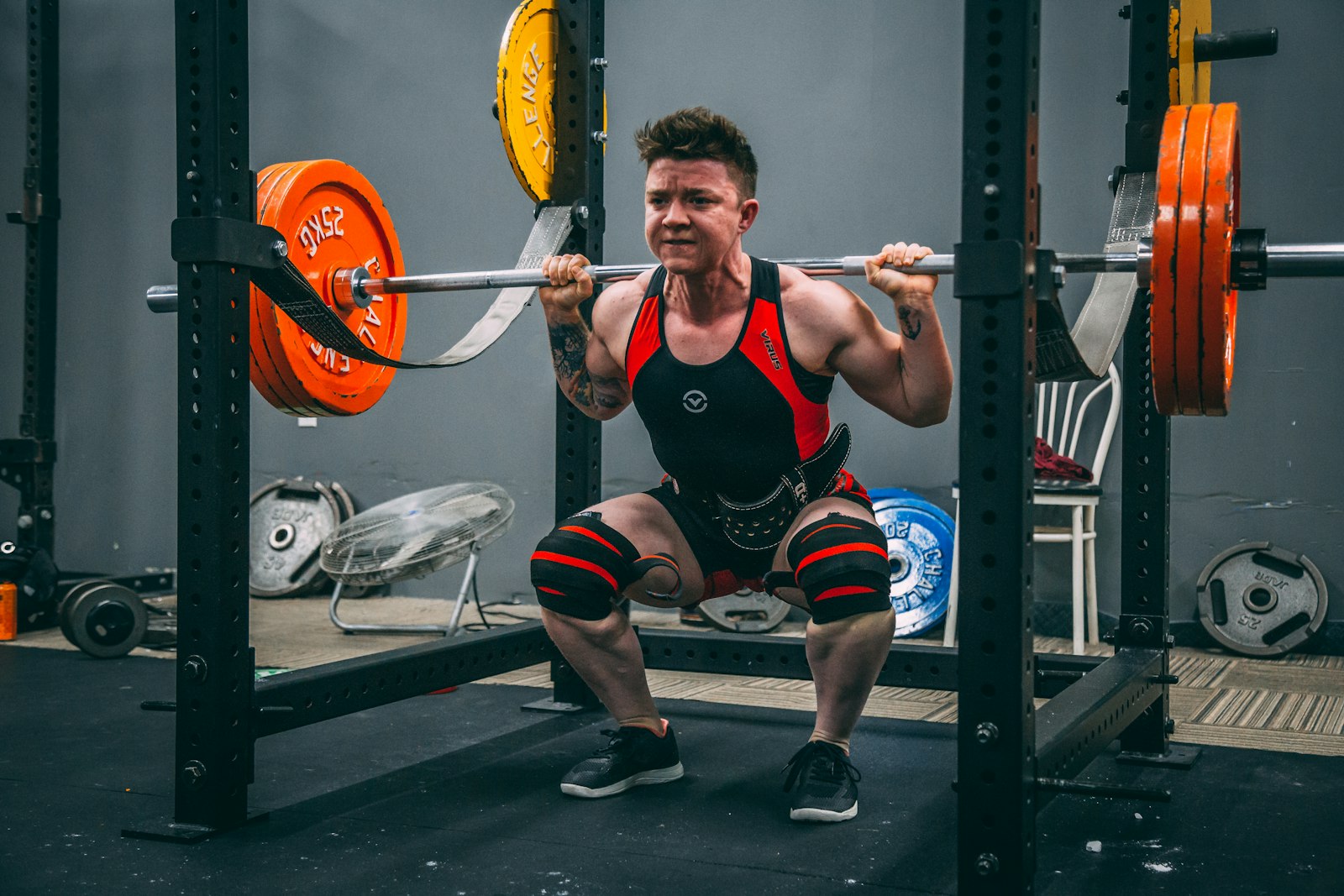 A person lifting weights in a gym, representing the muscle-growth goal these peptides are marketed against