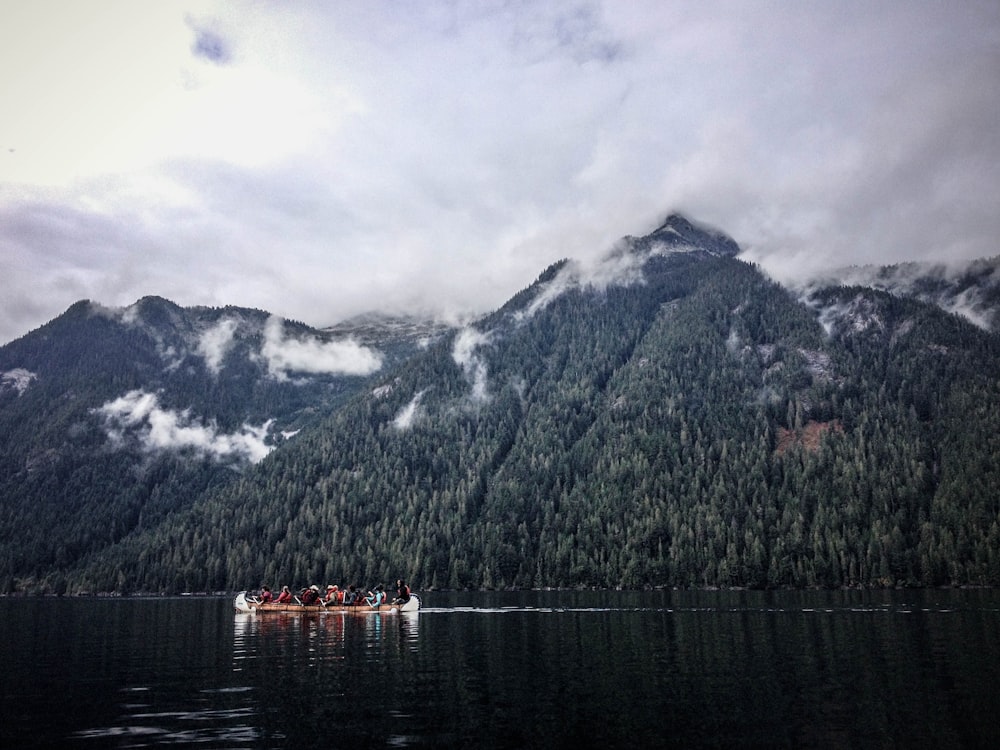 people on the boat near mountains