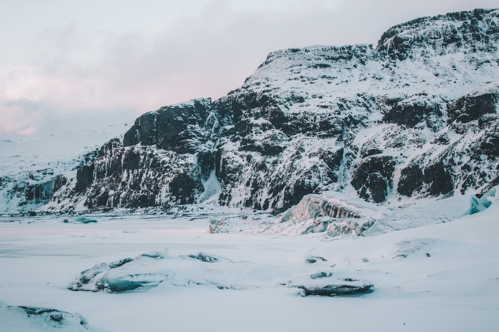 nature photography of snow capped mountain under cloudy during daytime