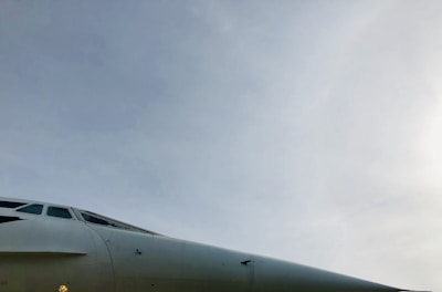 Side profile of a sleek smpat enterprises plane preparing for takeoff under clear blue skies.