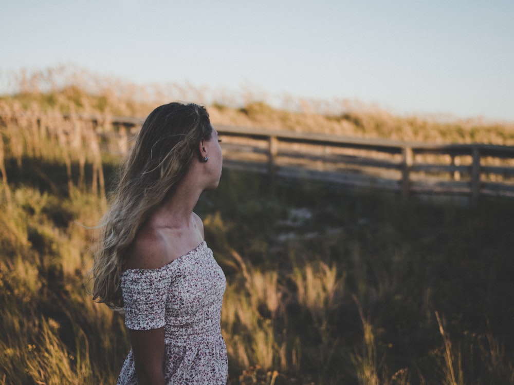 selective focus photography of woman on grass field